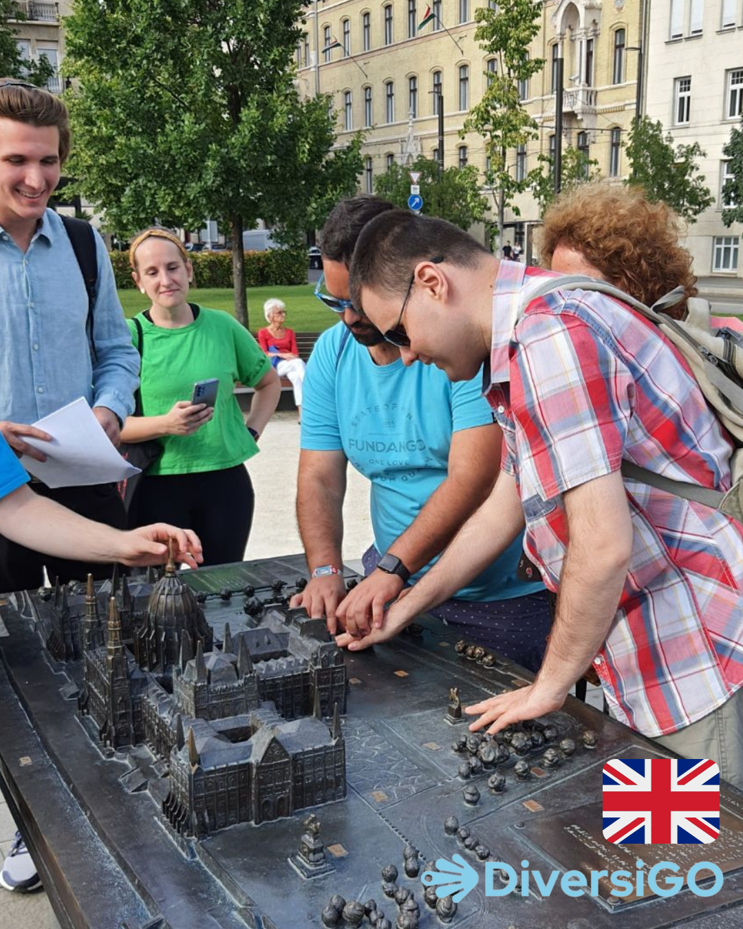 Tourists are observing the dimensions at the tactile model of the Hungarian Parliament Building and its surroundings.